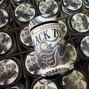 Close-up of multiple round tins with a black-and-white label that reads 'BLACK ZOID' and features an octopus illustration in a boxful display.