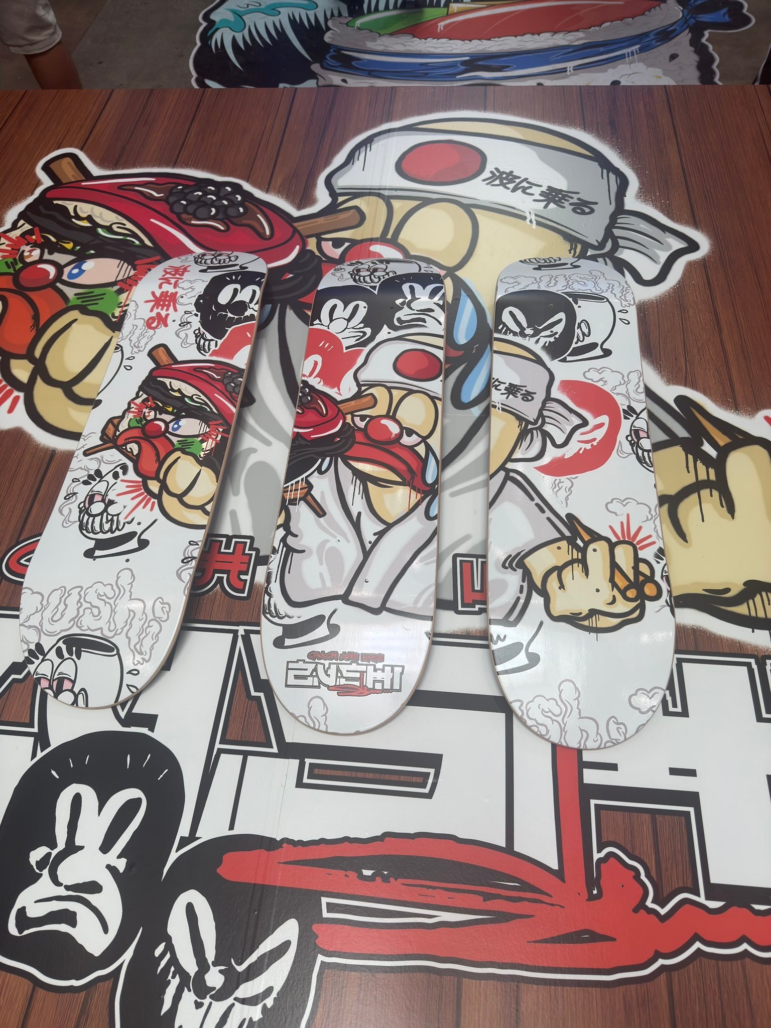 Zushi x Slawn Skateboard collection displayed against massive Black Zushi themed graffiti mural by THE TENCO