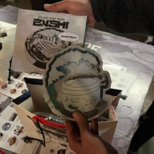 Zushi Metal Tray held in hand showing official Catch the Wave artwork and fierce character design