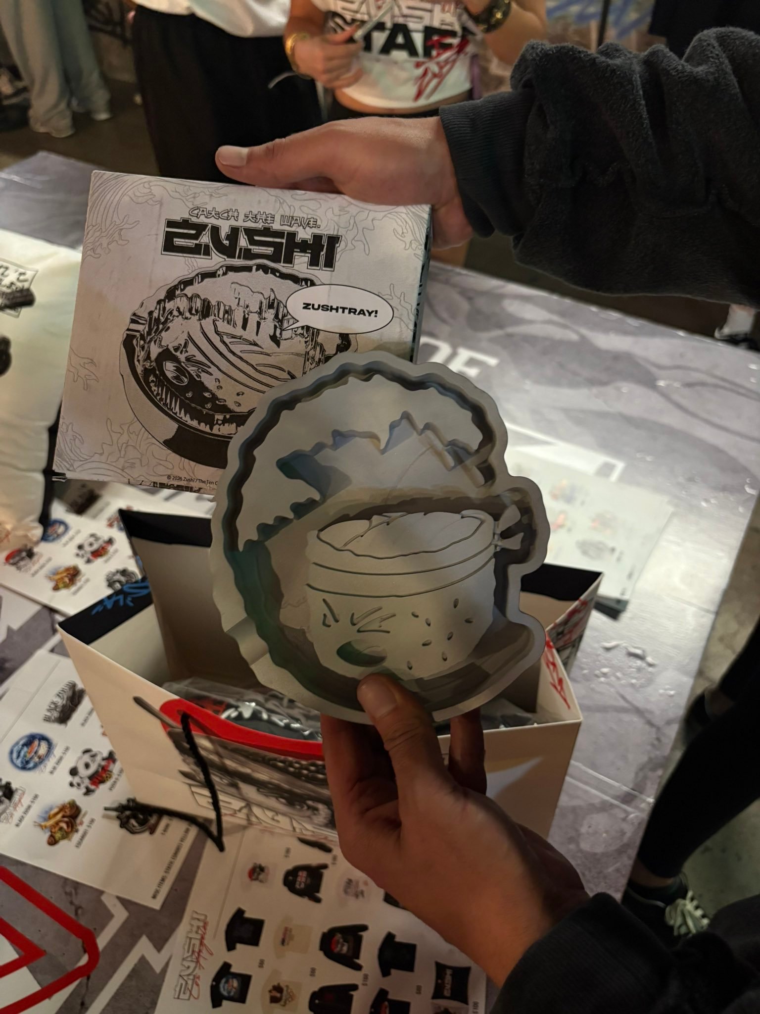 Zushi Metal Tray held in hand showing official Catch the Wave artwork and fierce character design