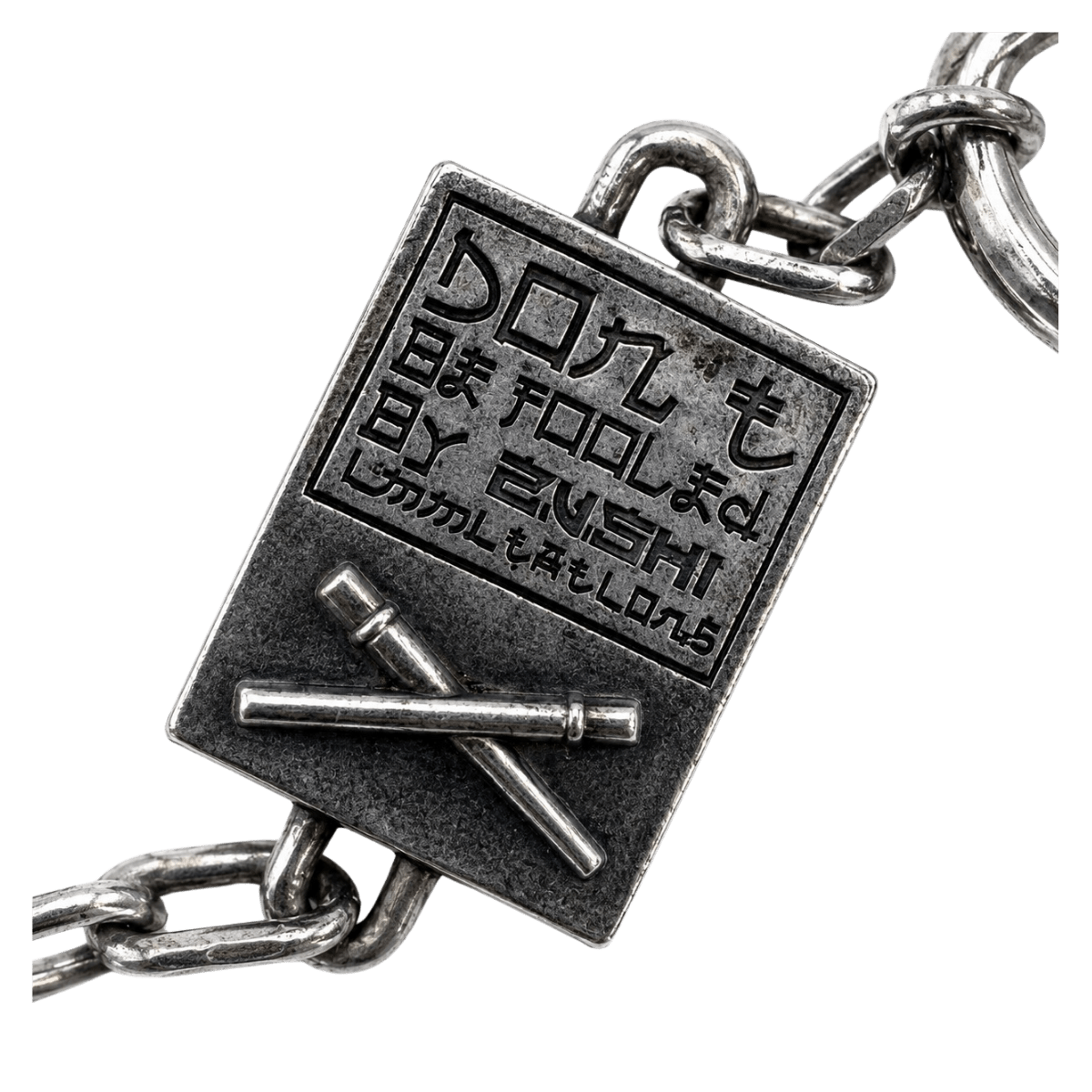 Zushi Lighter Chain pendant tag closeup with Japanese engraving and crossed design THE TENCO